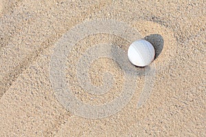 Golf ball on sand photo