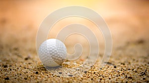 Golf ball on sand in golf course on sunset