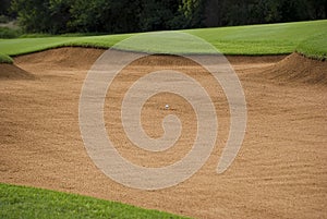 Golf Ball in the Sand Trap photo