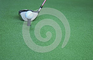 Golf ball on tee with driver club, in front of driver, driving r