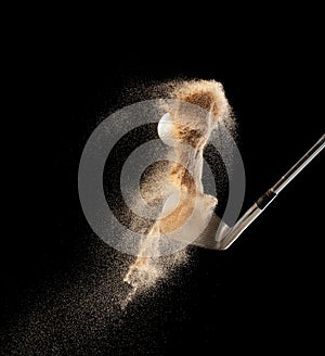 Golf ball tee explode from sand bunker. Golfer hit ball with club to sand explosion to green. Golf club hit ball tee in sand wedge