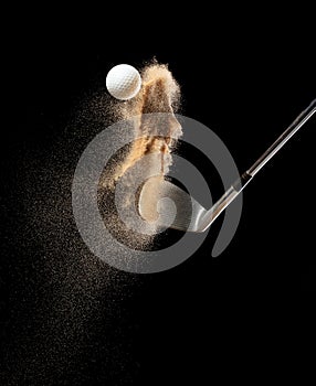 Golf ball tee explode from sand bunker. Golfer hit ball with club to sand explosion to green. Golf club hit ball tee in sand wedge