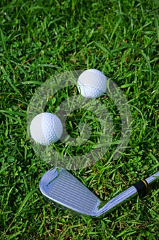 Golf ball and tee on golf green course background