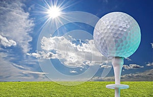 Golf ball on a tee with grass