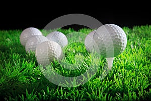 Golf ball and tee in green grass