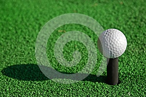 Golf ball on tee and imitate green