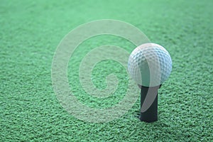 Golf ball on tee ready to be shot at a drivingrange