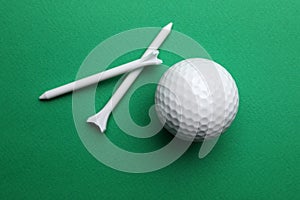Golf ball and tees on color background, flat lay