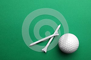 Golf ball and tees on color background, flat lay