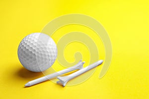 Golf ball and tees on color background. Sport equipment