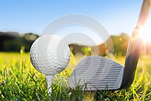 Golf ball on white tee and golf club