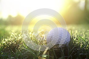 Golf balls on green lawns in beautiful golf courses with sun rise background