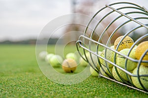 Golf balls and sticks on green golf course