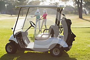 Golf buggy on field during sunny day