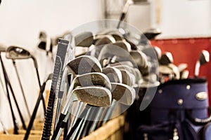 Golf caddy room storage room with sets of poles irons