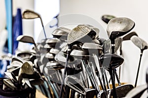 Golf caddy room storage room with sets of poles irons