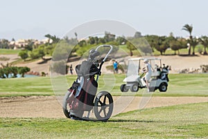 Golf caddy trolley on fairway