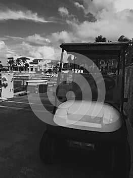 Golf car parked in cap Cana marina in Atlantic Ocean photo