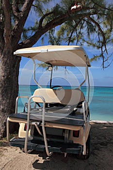 Golf cart on beach at tropical island resort hotel