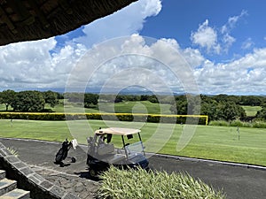 Golf cart of golf course with green grass field with blue sky