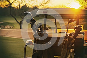 Golf cart 18th hole sun setting photo