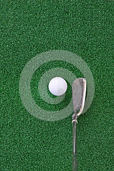 Golf club and ball on the artificial turf