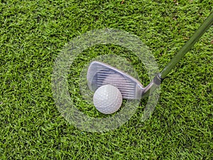 Golf club and ball on the artificial turf