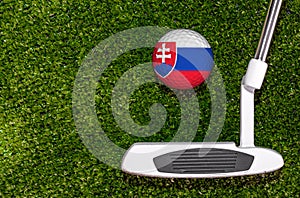 A golf club and a ball with flag Slovakia during a golf game