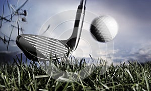 Golf club and ball in grass