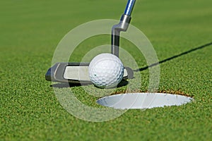 Golf club and ball in grass