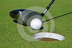 Golf club and ball in grass