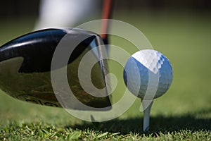 Golf club and ball in grass