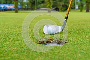 Golf club and ball in grass, Golf club and golf ball close up in grass field with sunset.