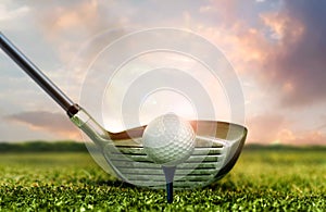 Golf club and ball on grass  under sunset sky lights