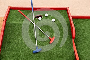 golf club, ball and hole