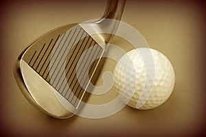 Golf club and ball sepia style image.