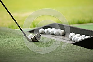 Golf club and balls in grass. Close up