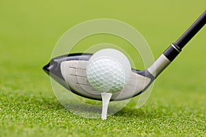 Golf club behind the ball