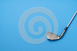 Golf club on blue background, sport concept