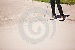 Golf, club and bunker with ball for shot with closeup of legs on pitch for recreational hobby. Sport, driving range and