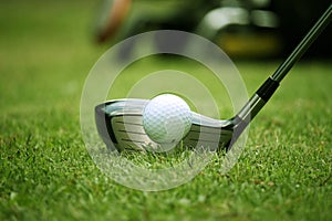 golf club and golf ball close up in grass field with sunset. Golf ball close up in golf coures