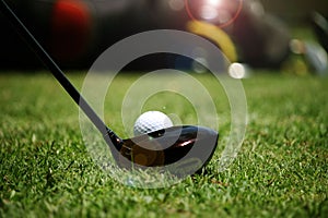 golf club and golf ball close up in grass field with sunset. Golf ball close up in golf coures