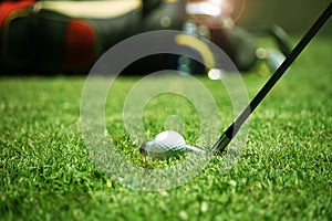 golf club and golf ball close up in grass field with sunset. Golf ball close up in golf coures