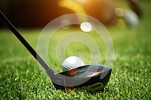 golf club and golf ball close up in grass field with sunset. Golf ball close up in golf coures