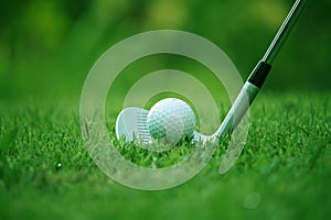 golf club and golf ball close up in grass field with sunset. Golf ball close up in golf coures