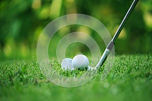 golf club and golf ball close up in grass field with sunset. Golf ball close up in golf coures