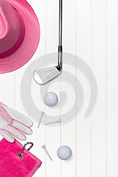 Golf club with golf ball and golf glove on wooden surface in blue