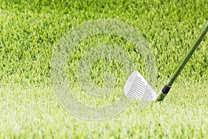 Golf club on green grass