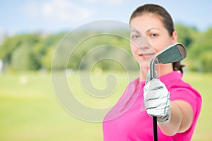 golf club in hand a golfer close up in focus