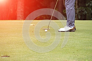 Golf clubs and golf ball in golf course